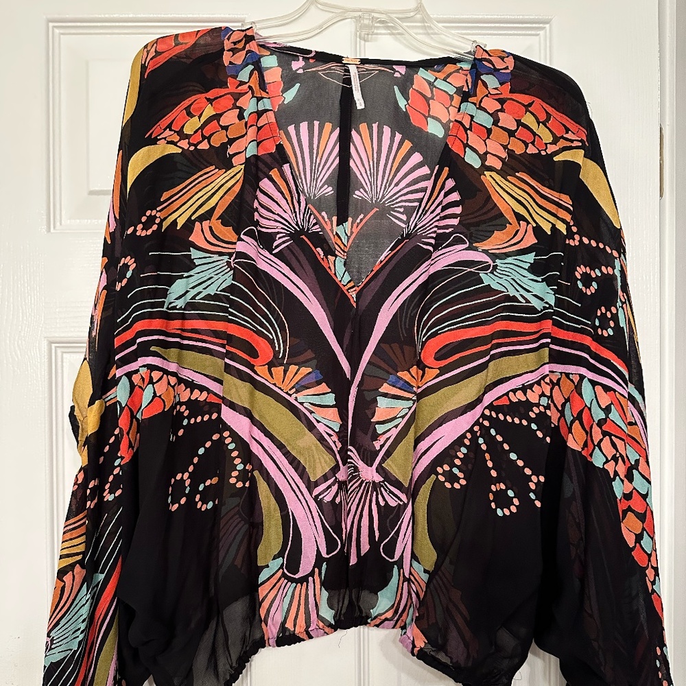 Free People v-neck sheer blouse, short with elastic bottom and winged sleeves